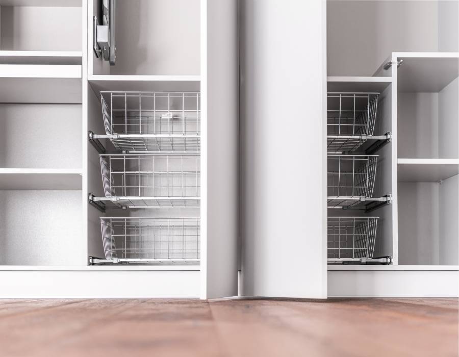 Custom closet organization system with pull-out metal wire baskets and open shelving, designed for efficient home storage and decluttering solutions.